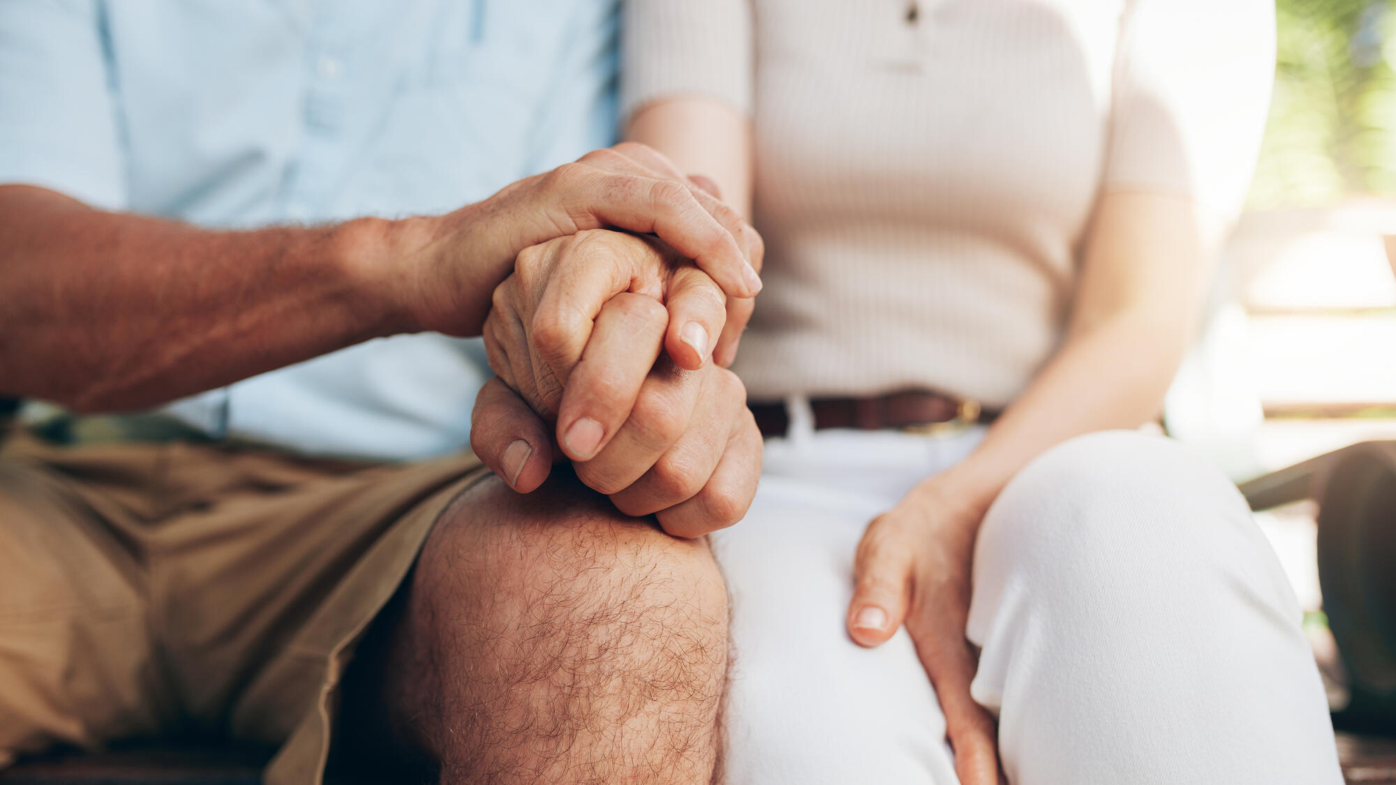 Two seniors holding hands