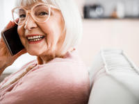 Senior woman having phone conversation and smiling