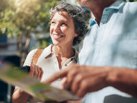 woman smiling with man looking at map